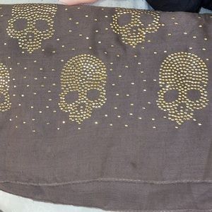Super nice brown scarf with skull details at the ends of scarf. Long, wide scarf